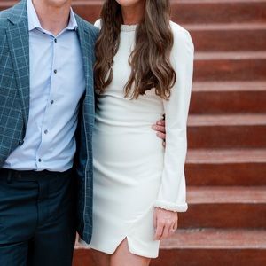 Pearl and bead embellished Likely white dress